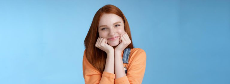 tenderness wellbeing beauty conept attractive young ginger girl pure skin blue eyes lean palms silly